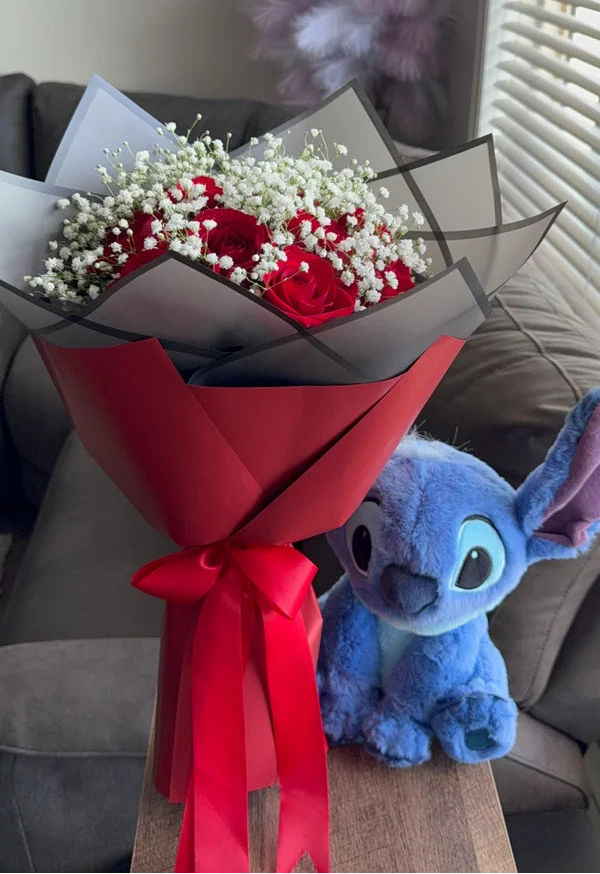 A dozen red roses with baby’s breath & Blue Stitch