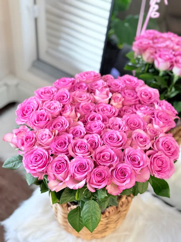 A blooming basket of 50 pink roses.